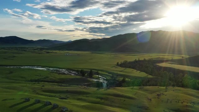 Aerial around view of steppe and mountains landscape in Orkhon valley at dawn, Mongolia, 4k