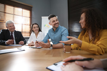 Group of people discussing questions at business seminar