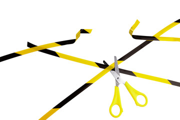 End of quarantine concept. Yellow and black warning stripes are cutting by scissors isolated on white background