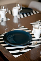 Beautiful dining table setup with blue plate