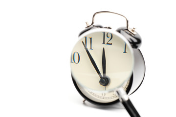 Enlarge the clock face that show almost midday or midnight of black vintage alarm clock.