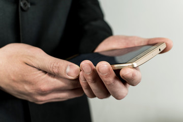 Close up of the hands taking a mobile.