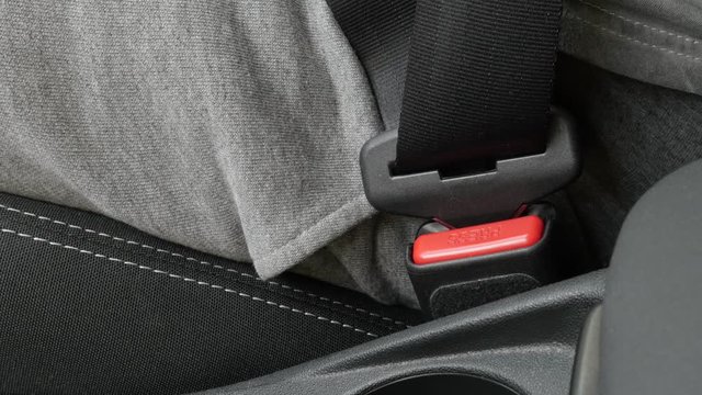 Securing 3-point seat belt onto car bracket 4K footage