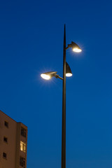 Modern lamp posts at night. Twilight