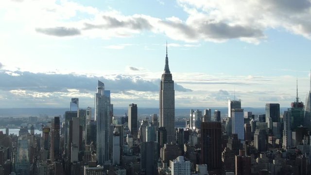 Quarter orbiting smooth aerial of Empire State Building skyline at golden hour