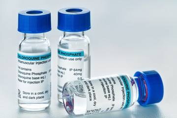 Chloroquine phosphate (generic name) drug in small injection bottles with blue caps (own label design with dummy data - not real product) Potential coronavirus cure concept