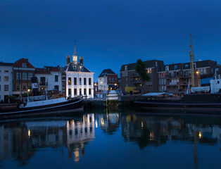 City of Schiedam at night. Twilight. Harbour and boats.