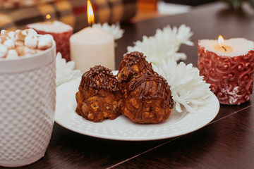 cake anthill on a plate on the table, cocoa with marshmallow in a white mug, home comfort