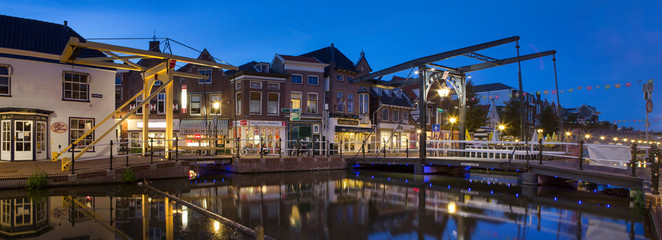 Fototapeta na wymiar City of Schiedam at night. Twilight. Draw bridge and canal. Panorama