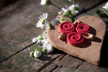Heart and white flowers on a wooden background (vintage)
