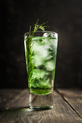 Sweet tequila based green cocktail with tarragon and rosemary. Selective focus. Shallow depth of field.