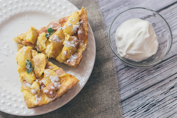 Apple pie for Breakfast on a white plate, wooden background