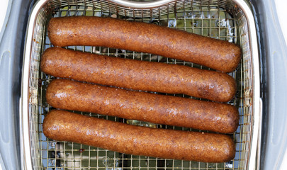 Frikadellen, a Dutch fast food snack in the oil