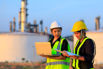 Smart two female engineer discussion together at refinery industry plant at industry factory center area. Engineering Concept