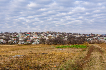 Plowed field at autumn. City Uman on a background. Ukraine