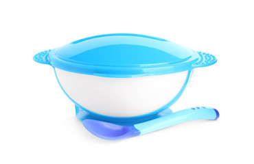 Light blue plastic baby bowl with spoon isolated on white. First food