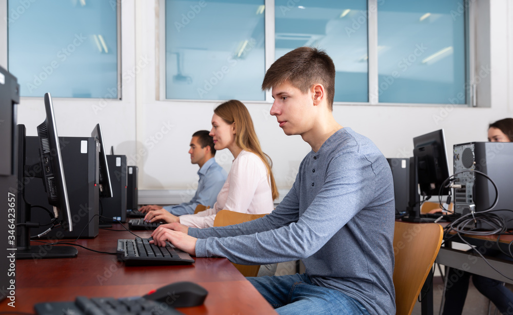 Canvas Prints Side view of focused female and male working