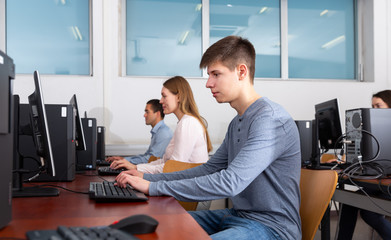 Side view of focused female and male working