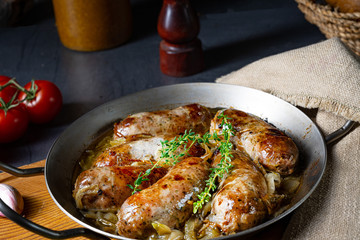 Homemade white sausage fried with onion and herbs