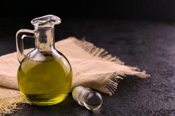 
Olive oil carafe on black background. Copy space.