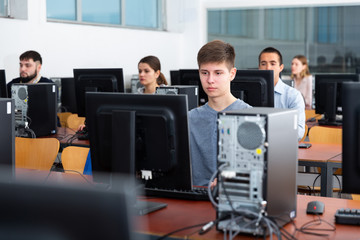 Fototapeta premium Female and male students working on computers