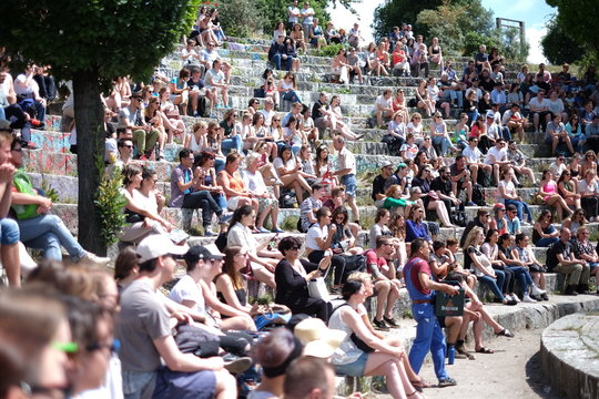 People Sitting At Amphitheater During Concert