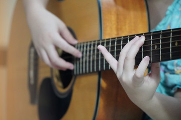 Girls practice playing acoustic guitar,Stay at home
