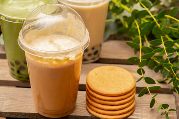  Fresh latte with cookies on wooden board