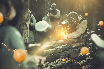 Paintball team aiming outdoors