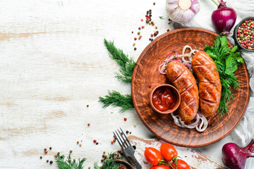 Juicy baked grilled sausages with vegetables on a board. Barbecue menu. Top view.
