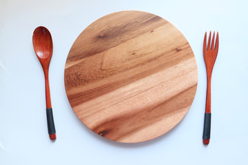 chopping board and fork on white background.