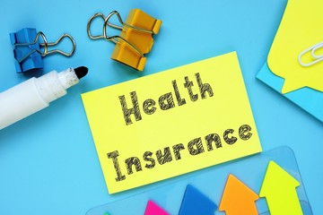 Financial concept about Health Insurance with inscription on the piece of paper.