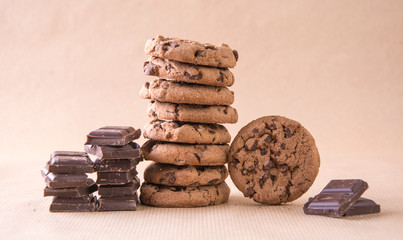 Cookies sweet biscuits American chocolate cake with chocolate cubes on a pastel background.