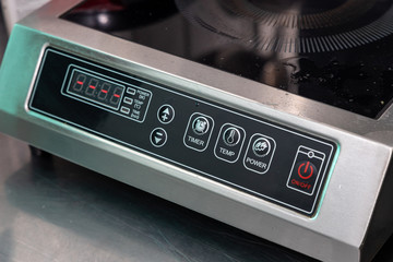 Obraz premium Close-up of the power button, temperature changes and other settings on the electric stove