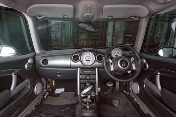 Disassembled car interior with doors. armchairs and other panels in a car workshop.Work at the auto...
