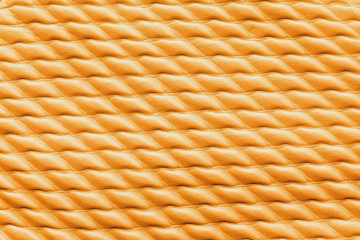 Texture of orange leather as background, closeup