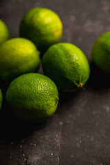 Juicy green limes on the rustic background. Selective focus. Shallow depth of field.