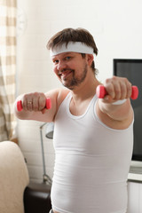 Fototapeta na wymiar Young attractive man engaged in fitness