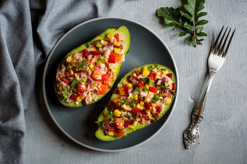 Avocado halves stuffed with tuna fish and vegetables