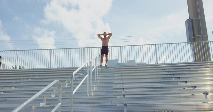 Athletic Man Catching Breath In Stadium