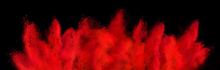 red holi paint color powder explosion isolated dark black background. industry beautiful party...