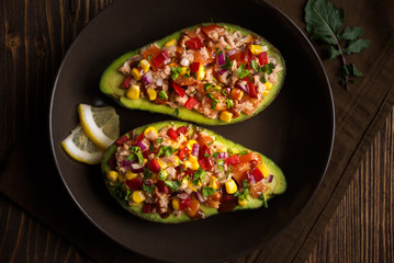 Avocado halves stuffed with tuna fish and vegetables