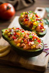 Avocado halves stuffed with tuna fish and vegetables