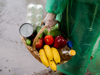 Volunteer delivery of necessary food in rainy weather, close-up of the basket with food.