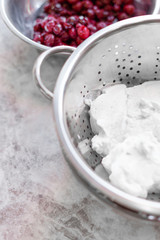 Fresh cottage cheese and berries in metal bowls on the table
