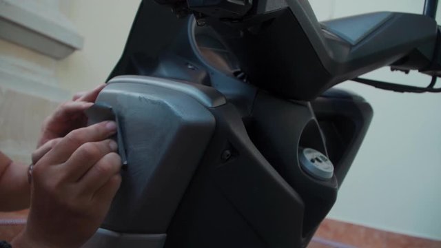 man hand polishing damaged motorcycle before painting with sandpaper