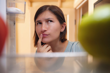 Pretty Woman Looking For Food In Refrigerator