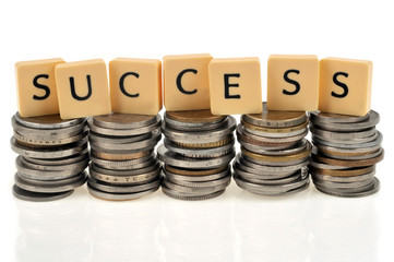 Success written with letters on stacks of coins