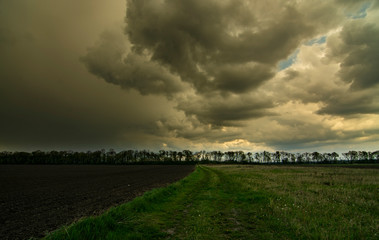 Storm And Rain Above Countryside Rural Field Or Meadow Landscape 