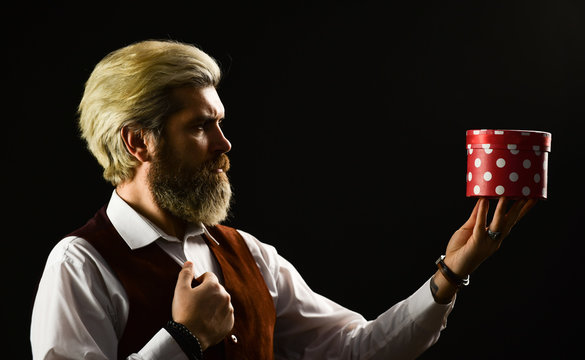 Exclusive and unique. Delivering precious product. Perfect gift. Online shopping. Black friday. Handsome man gift box. Mature bearded hipster hold present box. Box holiday package. Special occasion